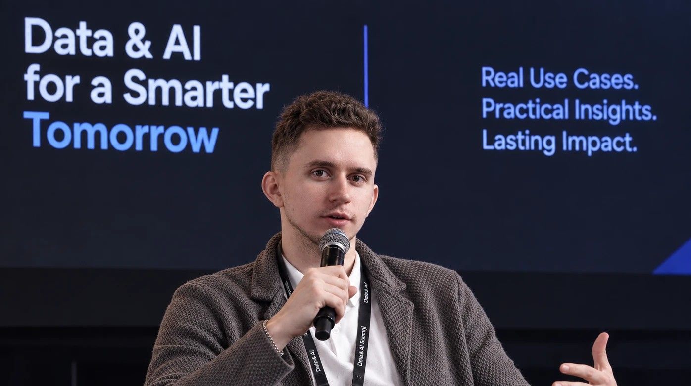 Sviat Nahirnyi speaking with a microphone on a panel at the Data & AI Summit